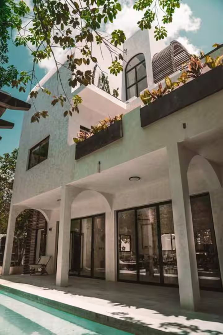 Villa exterior with pool and arched walkway