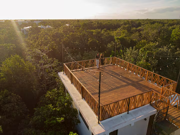 Rooftop deck overlooking the jungle at sunset