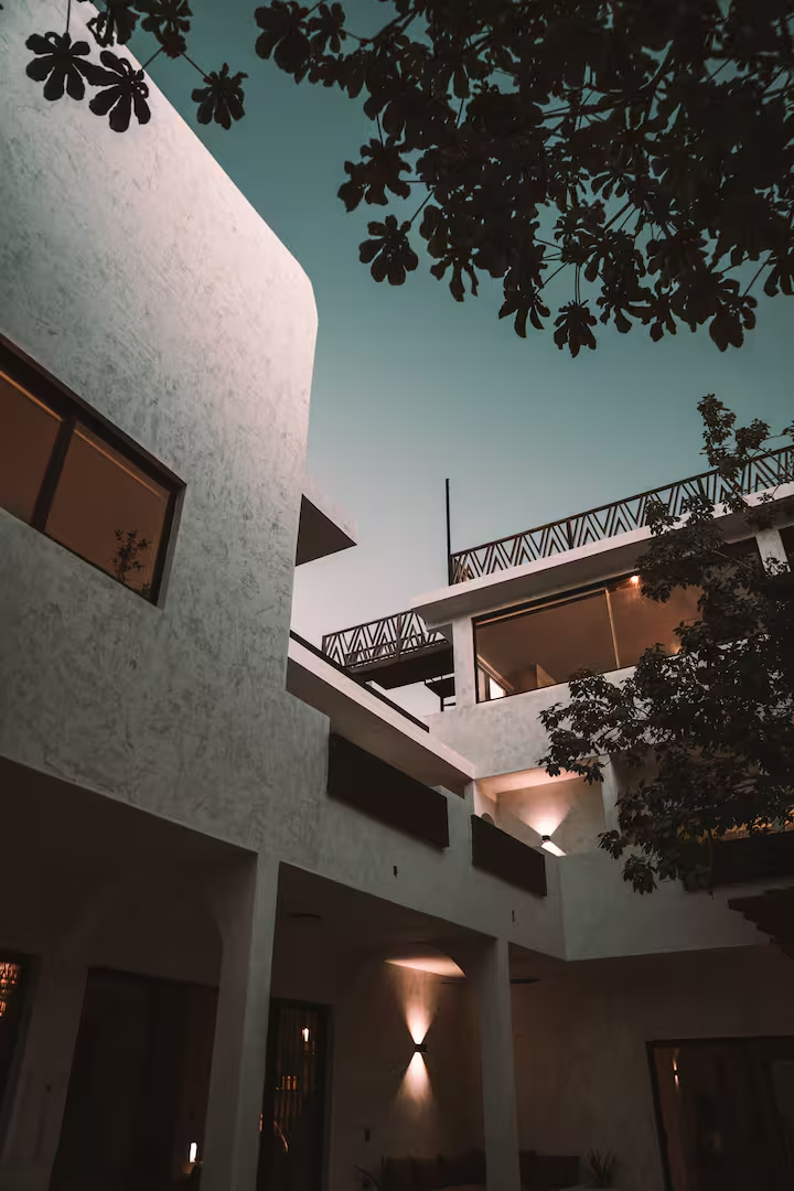Villa courtyard lit warmly at dusk